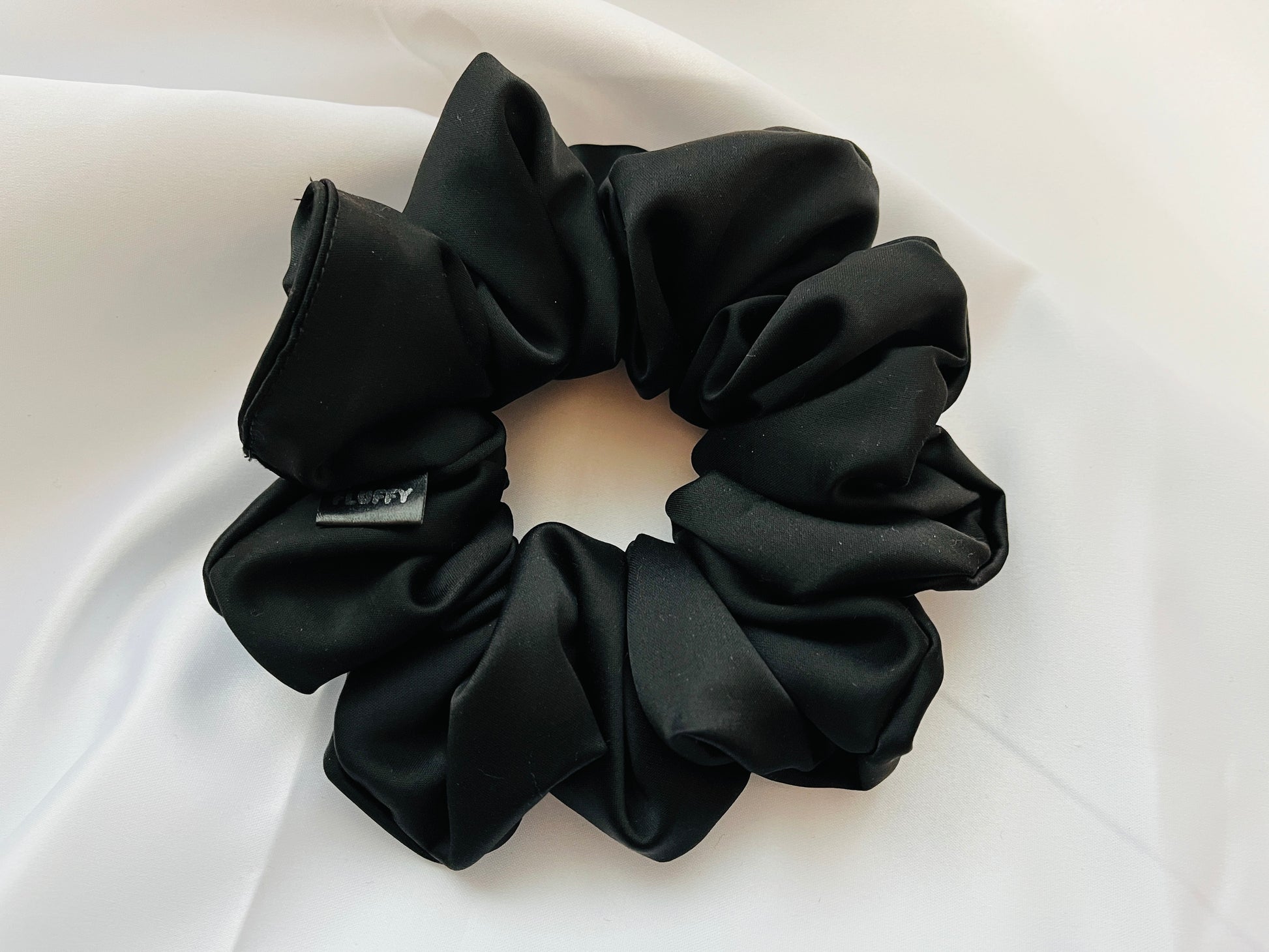 Black Satin Scrunchie Stylish and durable. You are seeing our satin scrunchies in 3 sizes..  The sizes of our Satin Scrunchies are Large, Medium and Mini.  Simply select the size you want in the drop down menu and add them to the card.   Our Satin Scrunchies are perfect for all hair types and every person. We have multiple colors and sizes available